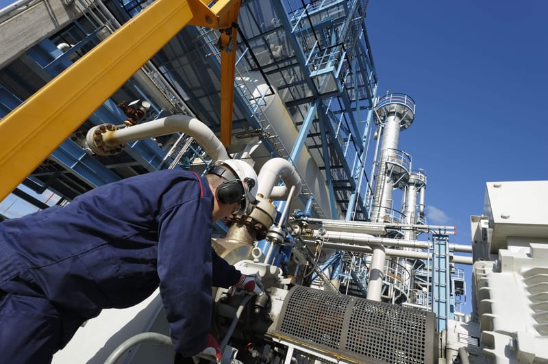 A refinery worker operating equipment that can release fugitive emissions in Alberta.
